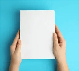 Hands holding flatly a bare white book cover overt a blue background